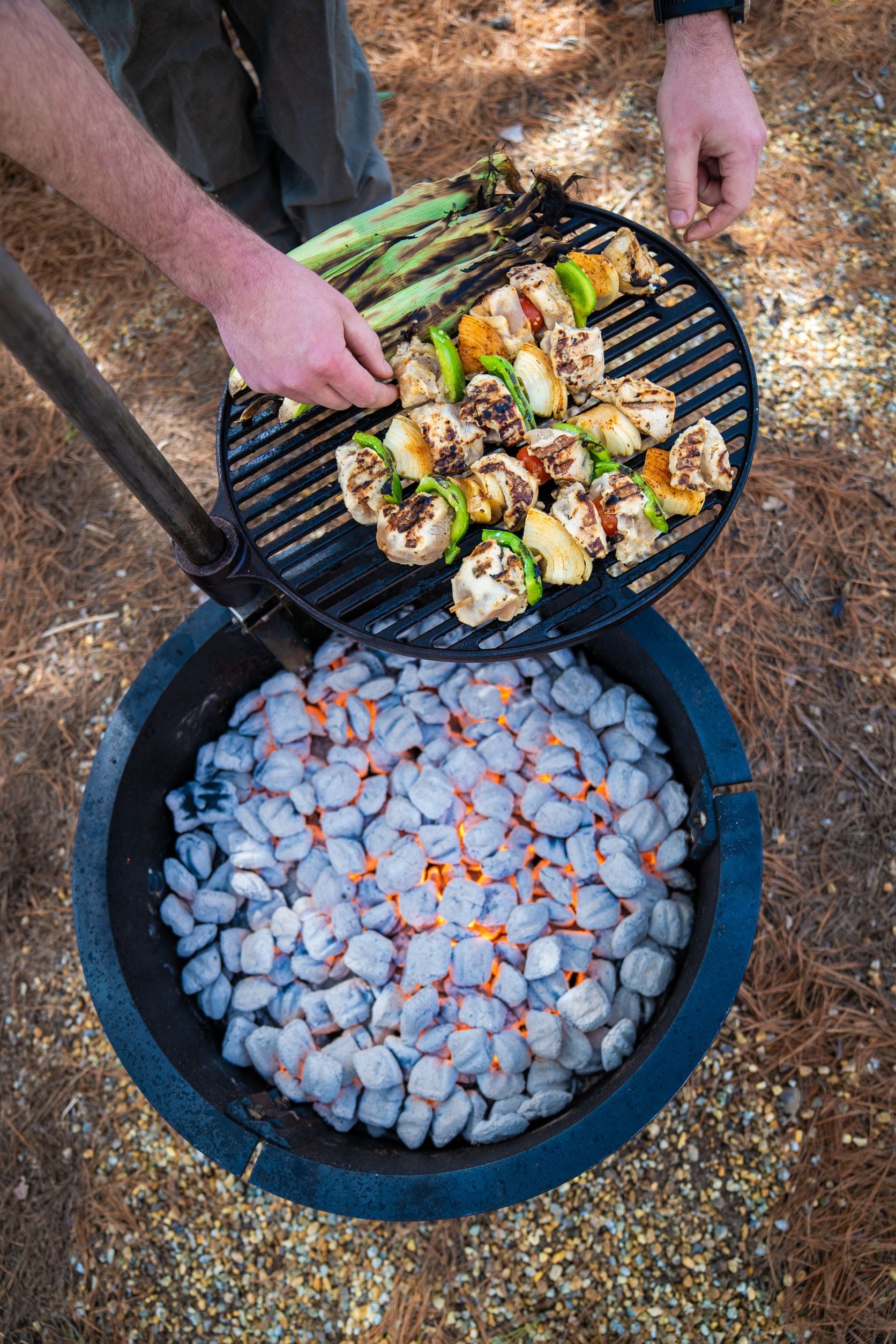 Sherman Cooker using charcoal to grill
